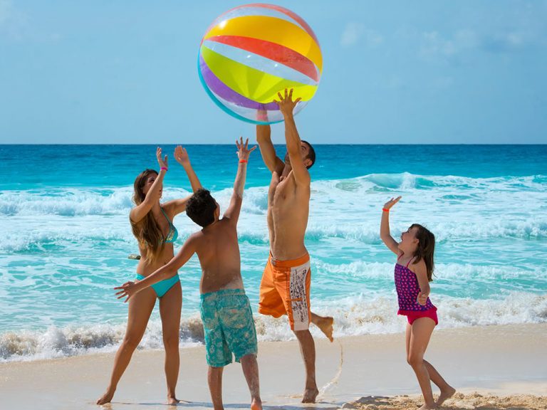 family playing on the beaches of the Riviera Maya
